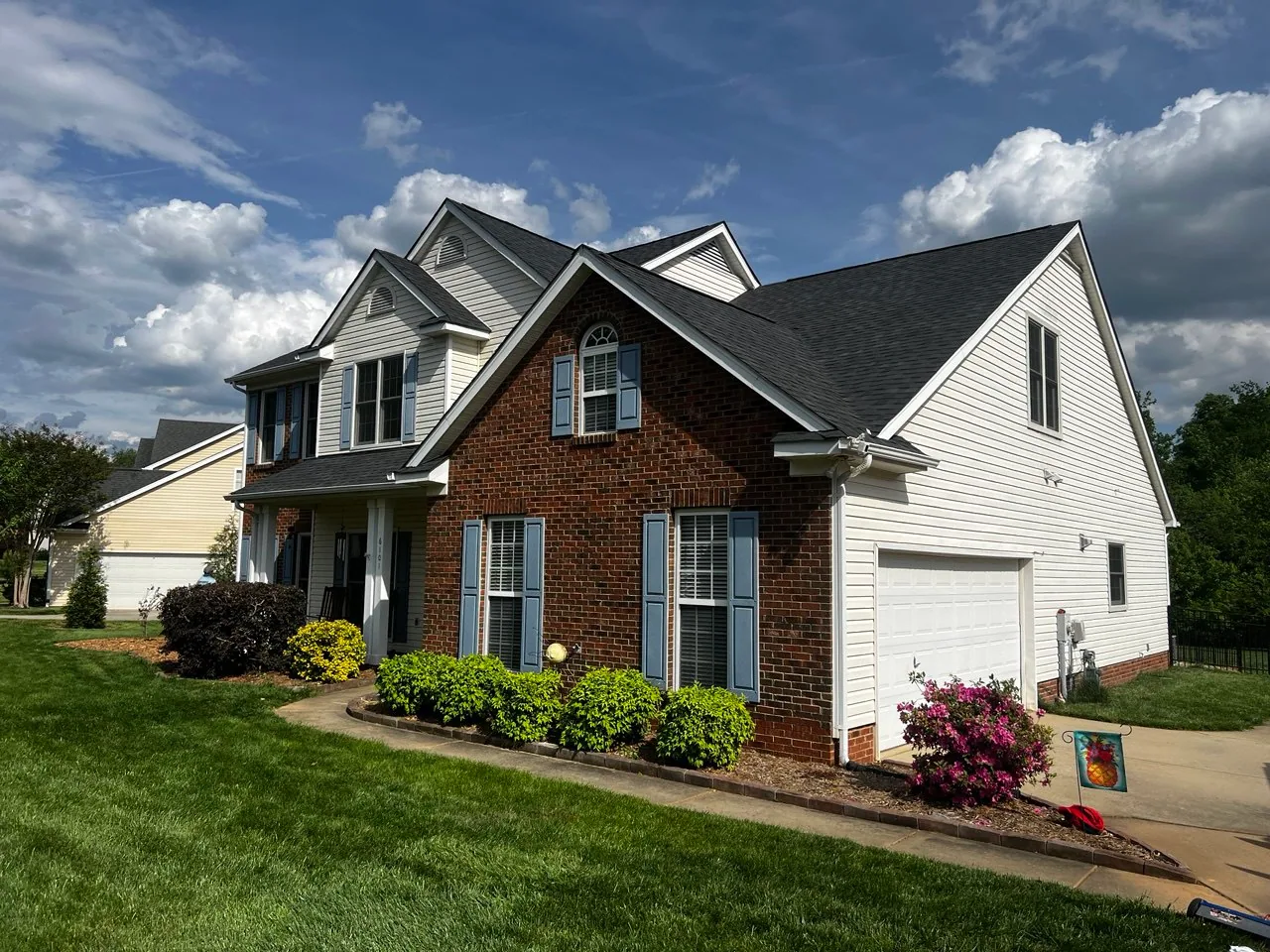 Triumph Roofing project on a brick and white home in Matthews, North Carolina
