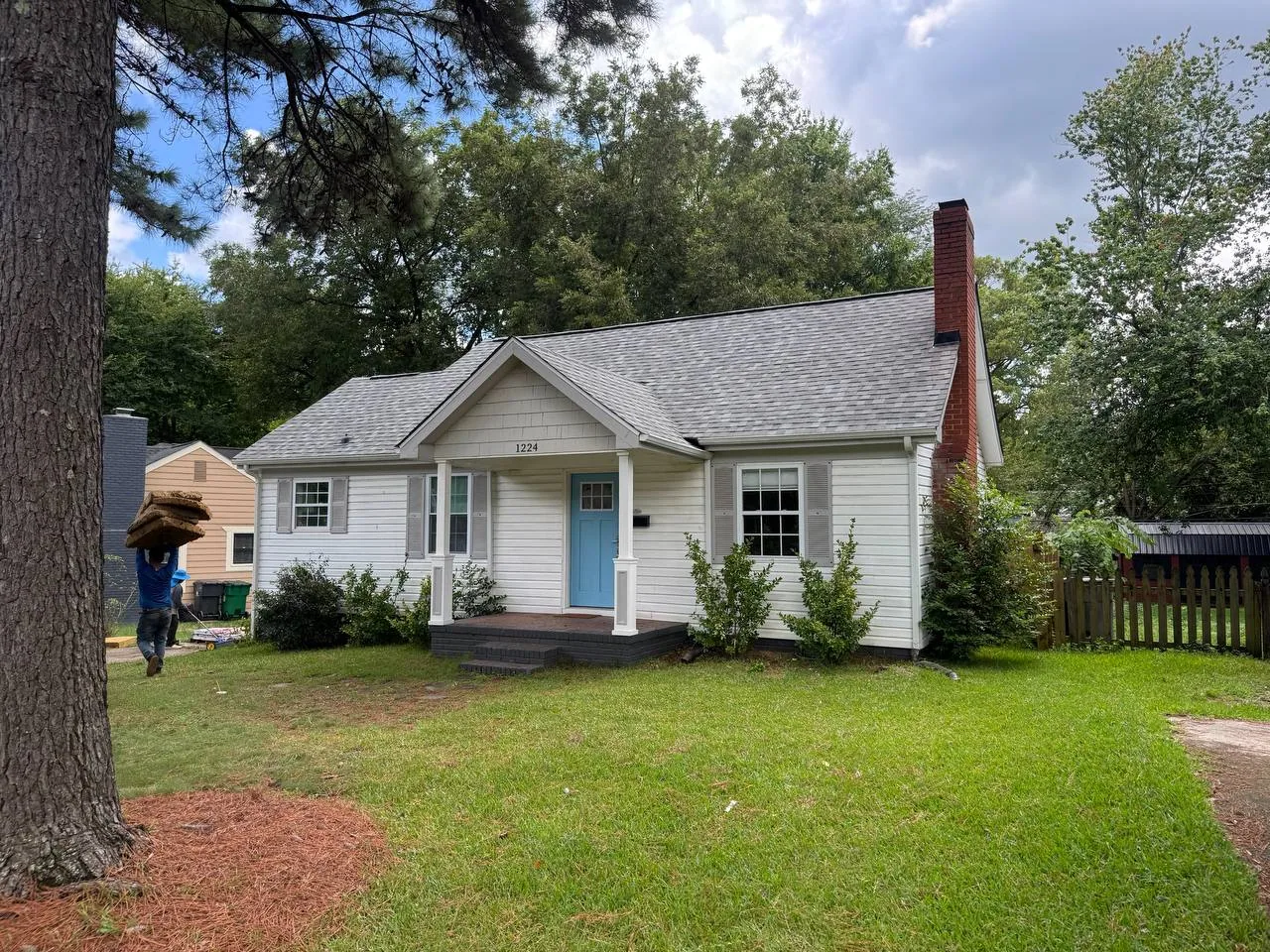 Triumph Roofing project on a light siding home with a blue front door in Monroe, North Carolina
